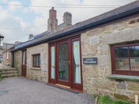 An exterior view of a stone building with a door and windows at Little Tregarrick in Helston