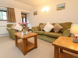 A living room with sofas and a coffee table at Little Tregarrick in Helston