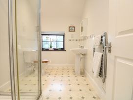 A bathroom with a shower, toilet, and sink at Little Tregarrick in Helston