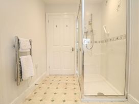 A bathroom with a shower and towel rail at Little Tregarrick in Helston