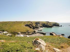 A coastal view with water and rocky land at Little Tregarrick in Helston