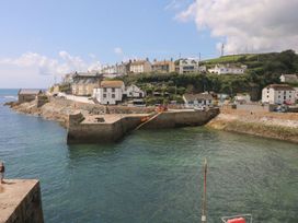 A coastal view with houses and boats at Little Tregarrick Helston