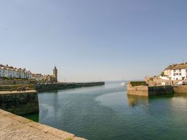 A harbor with buildings and boats at Little Tregarrick in Helston
