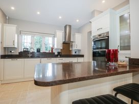 A kitchen with cabinets and a stove at Woodlands house in Ringwood