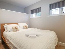 A bedroom with a bed and pillows at Woodlands house in Ringwood
