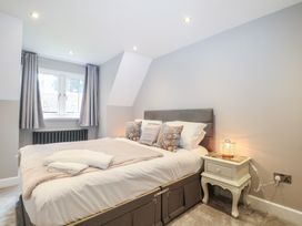 A bedroom with a bed and bedside table at Woodlands house in Ringwood