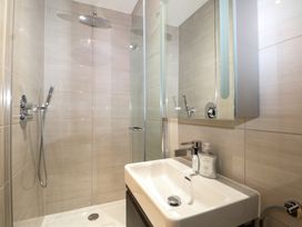 A bathroom with a shower and sink at Woodlands house Ringwood