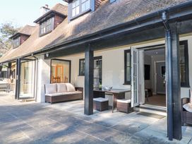An outdoor seating area with furniture at Woodlands House in Ringwood