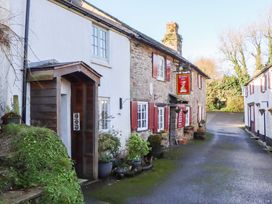 A building exterior with a front door and sign at Park Cottage in Kingsbridge
