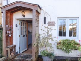 An entrance with a door and plants at Park Cottage in Kingsbridge