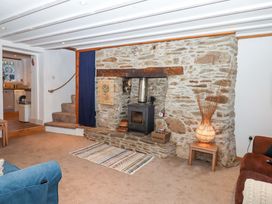 A living room with a fireplace and a sofa at Park Cottage in Kingsbridge
