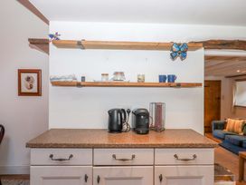 A kitchen with a coffee maker and kettle on the counter at Park Cottage in Kingsbridge