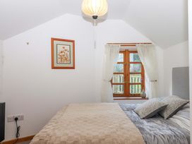 A bedroom with a bed and a window at Park Cottage in Kingsbridge