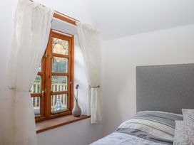 A bedroom with a window and bed at Park Cottage in Kingsbridge
