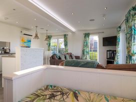 A living room with a sofa and television at 114 - The Residance Redruth