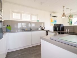 A kitchen with a sink and air fryer at 114 - The Residance Redruth