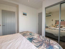A bedroom with a bed and a door at 114 - The Residance in Redruth
