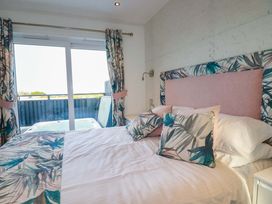 A bedroom with a bed and hot tub visible at 114 - The Residance in Redruth