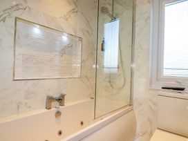 A bathroom with a bathtub and shower in Redruth