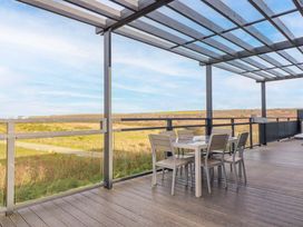 An outdoor dining area with a table and chairs at 114 - The Residance in Redruth