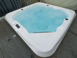 A hot tub filled with water in an outdoor area at 114 - The Residance Redruth