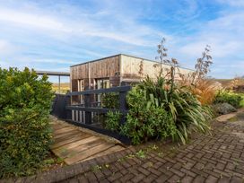An outdoor area with a wooden building and pathway at 114 - The Residance in Redruth