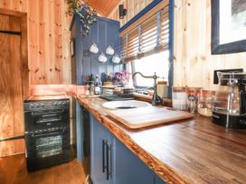 A kitchen with an oven and sink at Dunfell Shepherd's Hut in Appleby-In-Westmorland