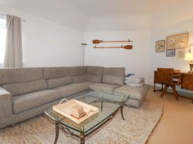 A living room with a sectional sofa and a coffee table at Cribba