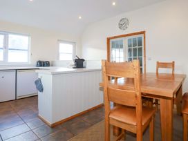 A kitchen with a table and chairs at Cribba 