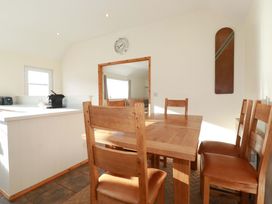 A dining room with a wooden table and chairs at Cribba