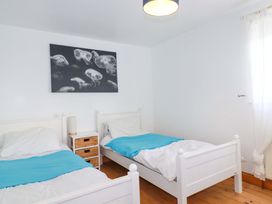 A bedroom with two beds and a picture of jellyfish on the wall at Cribba