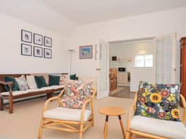 A living room with seating and doorway to kitchen at Cribba in Port Isaac