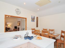 A kitchen with a table and chairs at Cribba Port Isaac