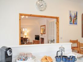 A kitchen with coffee maker and pastries at Cribba in Port Isaac