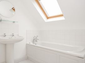 A bathroom with a wash basin and bathtub at Cribba in Port Isaac