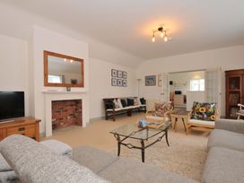 A living room with a television and a fireplace at Cribba in Port Isaac