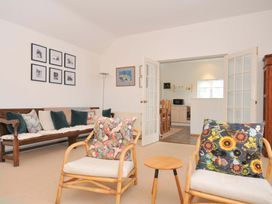 A living room with a sofa and chairs at Cribba, Port Isaac
