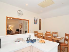 A kitchen with dining area and counter at Cribba in Port Isaac