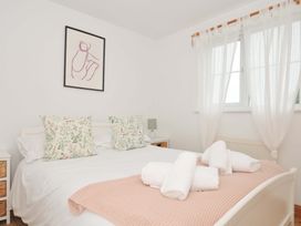 A bedroom with a bed, pillows, and towels at Cribba in Port Isaac