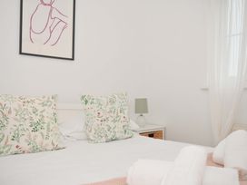 A bedroom with pillows and a lamp at Cribba in Port Isaac