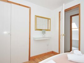 A bedroom with a mirror and lamp at Cribba in Port Isaac