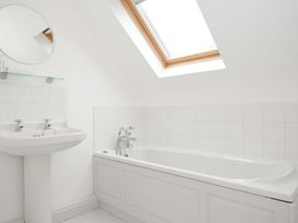 A bathroom with a bathtub and sink at Cribba in Port Isaac