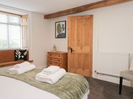 A bedroom with a bed and towels on it at No.2 The Flags in Grange-over-Sands