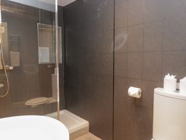 A bathroom with shower toilet and washbasin at No.2 The Flags in Grange-over-Sands