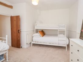 A bedroom with bunk bed and single bed at No.2 The Flags in Grange-over-Sands