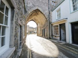 An archway leading to a street with buildings at No.2 The Flags, Grange-over-Sands