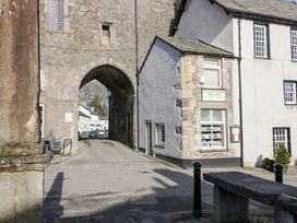 An archway leading to a street with a bookshop at No.2 The Flags in Grange-over-Sands