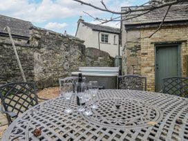 An outdoor patio with a table and chairs at No.2 The Flags Cartmel