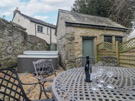 An outdoor area with a hot tub and table in No.2 The Flags in Cartmel