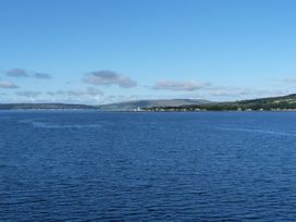 A view of water and land with buildings at Serenity Lodge Wemyss Bay